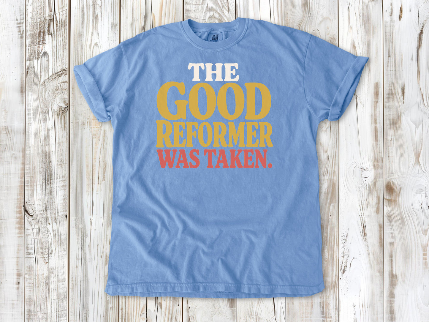 Washed Denim garment-dyed tee with The Good Reformer Was Taken Pilates studio graphic.