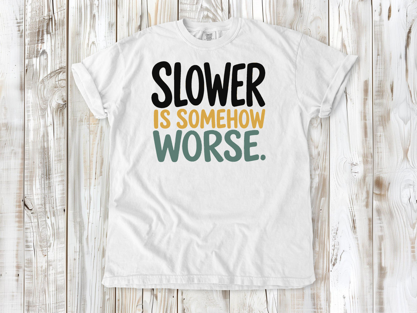 White garment-dyed tee with Slower Is Somehow Worse Pilates workout graphic.