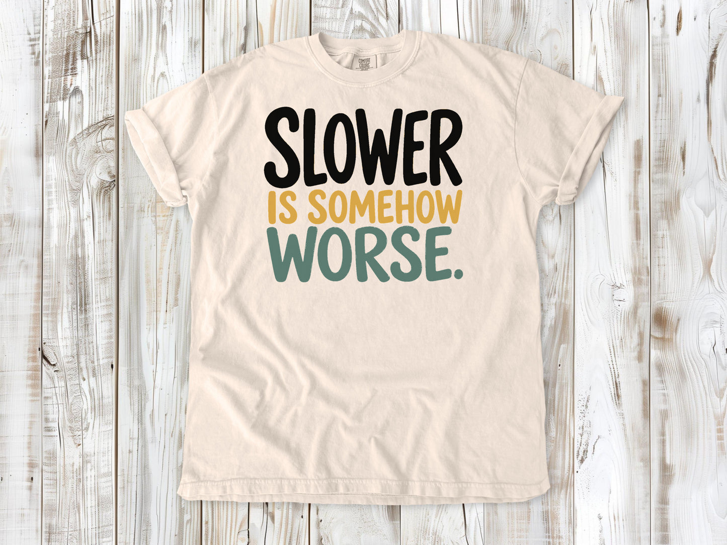 Ivory garment-dyed tee with Slower Is Somehow Worse Pilates workout graphic.