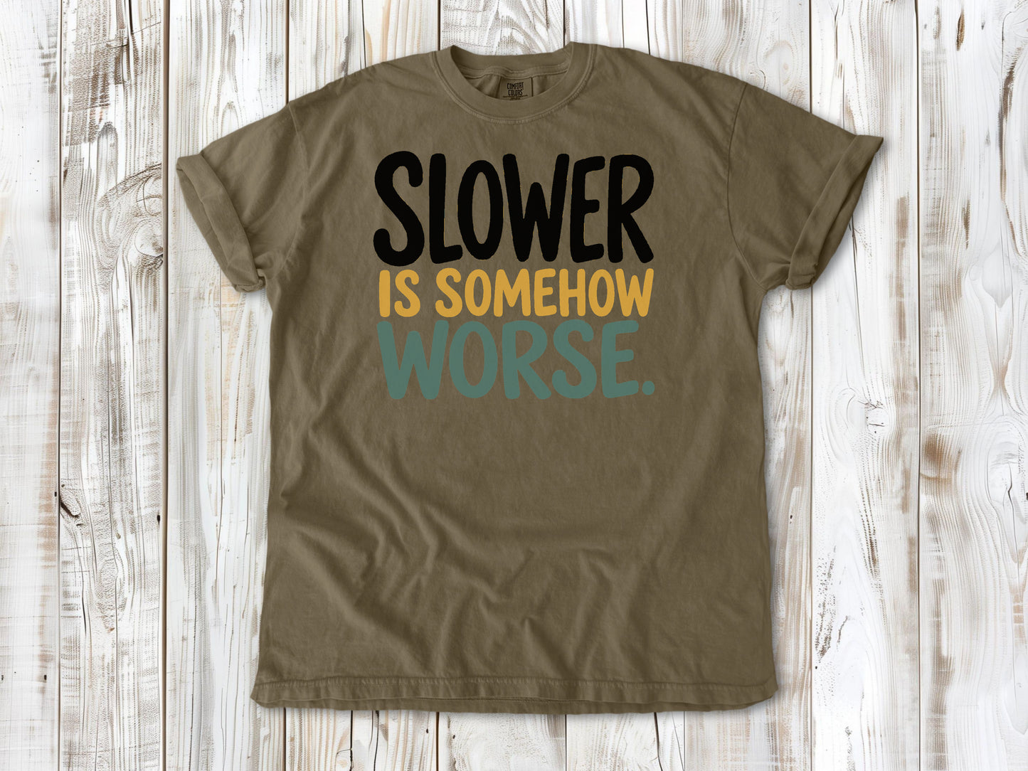 Khaki garment-dyed tee with Slower Is Somehow Worse Pilates workout graphic.