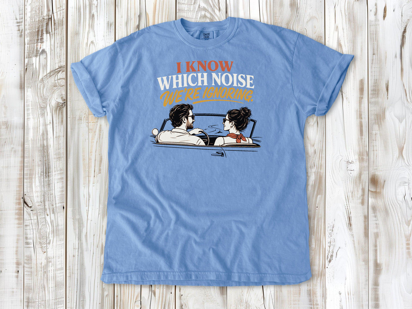 Washed Denim garment-dyed tee with I Know Which Noise We Are Ignoring car repair graphic.