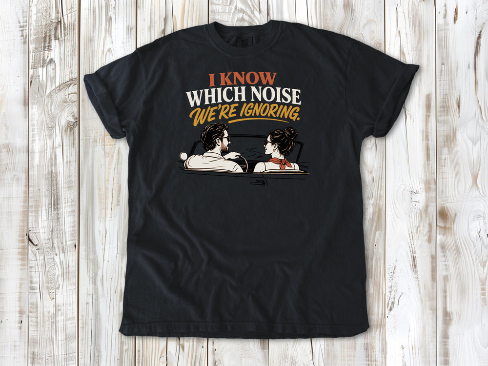 Graphite garment-dyed tee with I Know Which Noise We Are Ignoring car repair graphic.