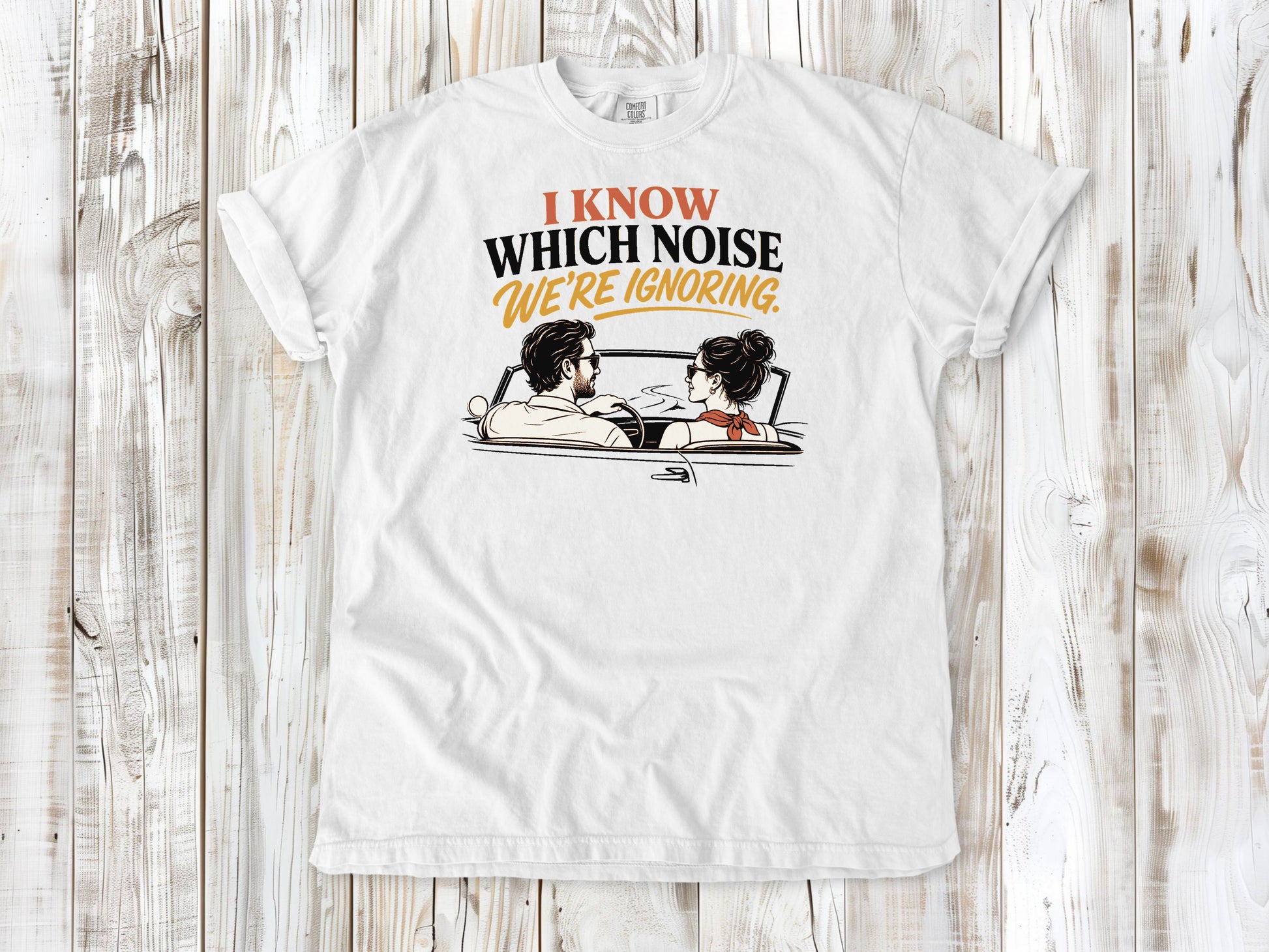 White garment-dyed tee with I Know Which Noise We Are Ignoring car repair graphic.
