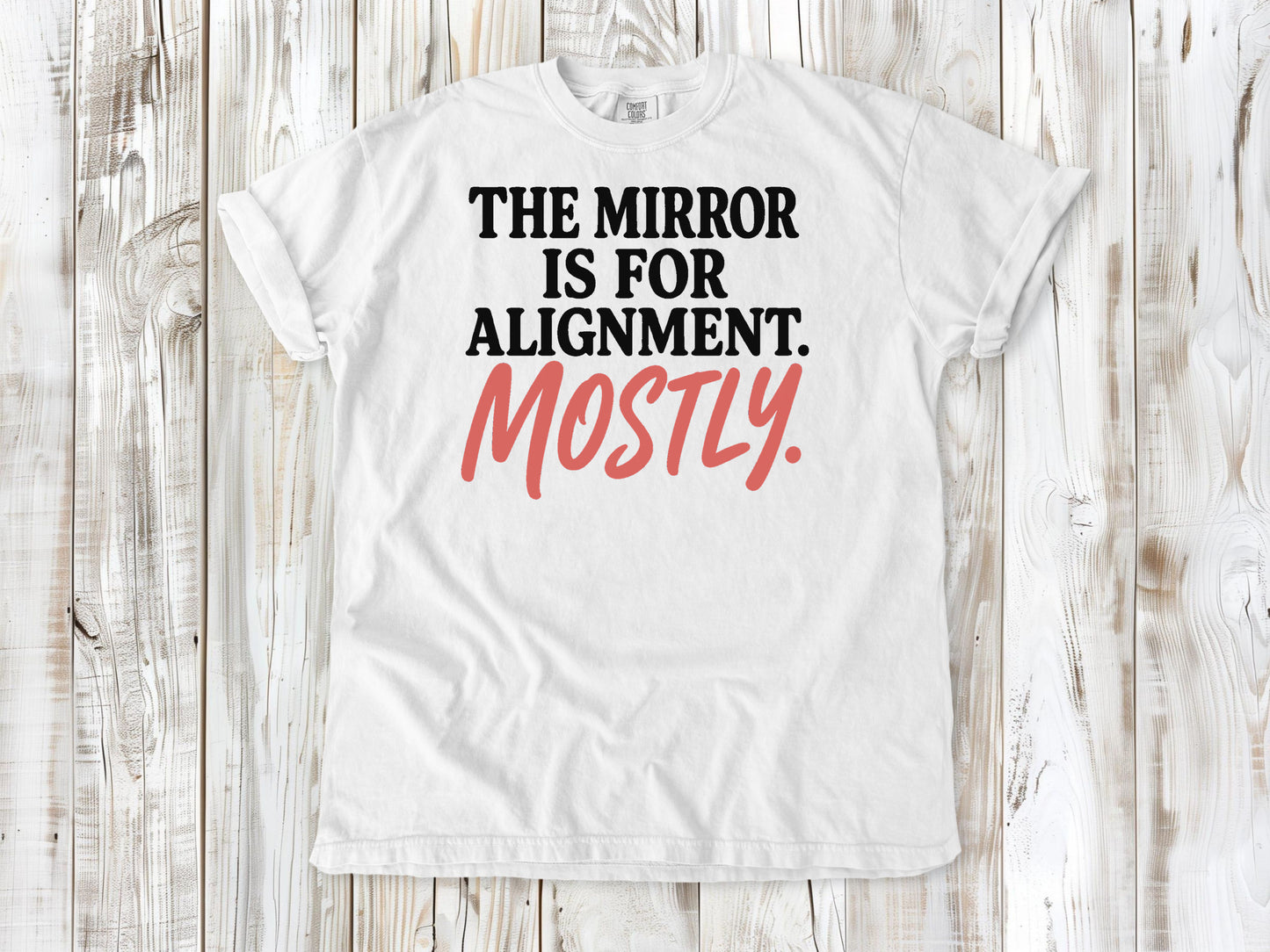 White garment-dyed tee with The Mirror Is for Alignment Mostly Pilates studio graphic.