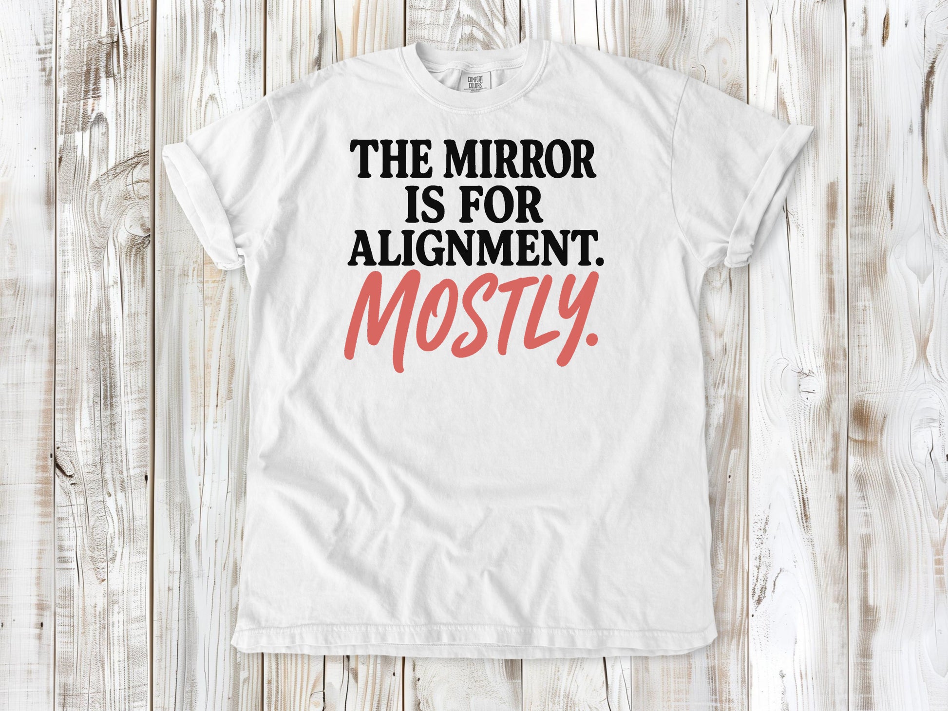 White garment-dyed tee with The Mirror Is for Alignment Mostly Pilates studio graphic.