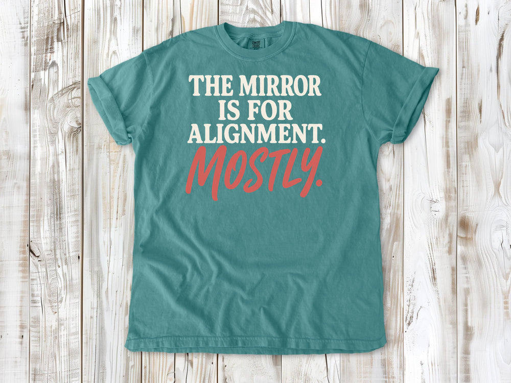 Seafoam garment-dyed tee with The Mirror Is for Alignment Mostly Pilates studio graphic.