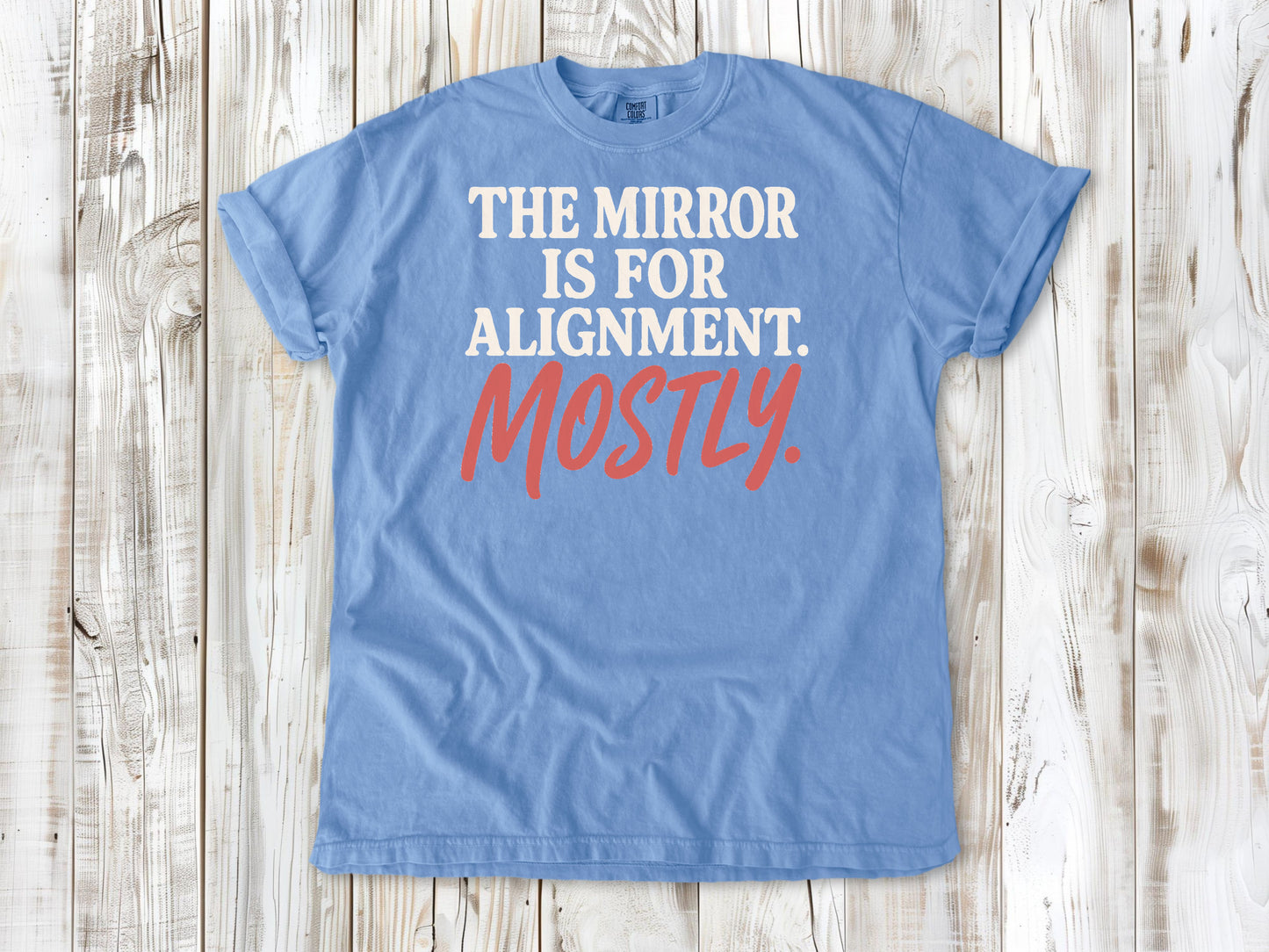 Washed Denim garment-dyed tee with The Mirror Is for Alignment Mostly Pilates studio graphic.
