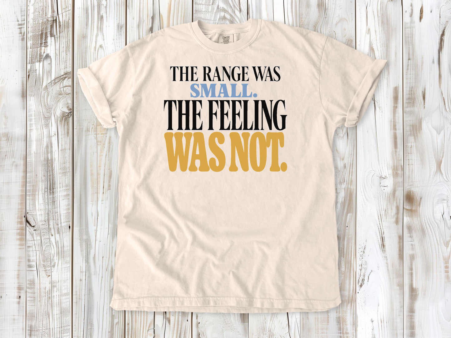 Ivory garment-dyed tee with The Range Was Small The Feeling Was Not Pilates graphic.