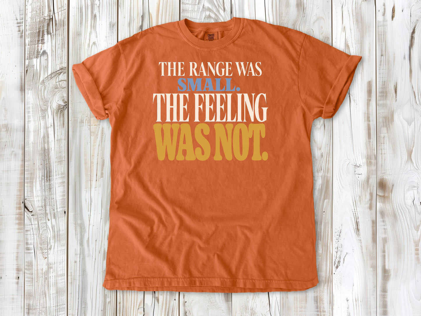Burnt Orange garment-dyed tee with The Range Was Small The Feeling Was Not Pilates graphic.