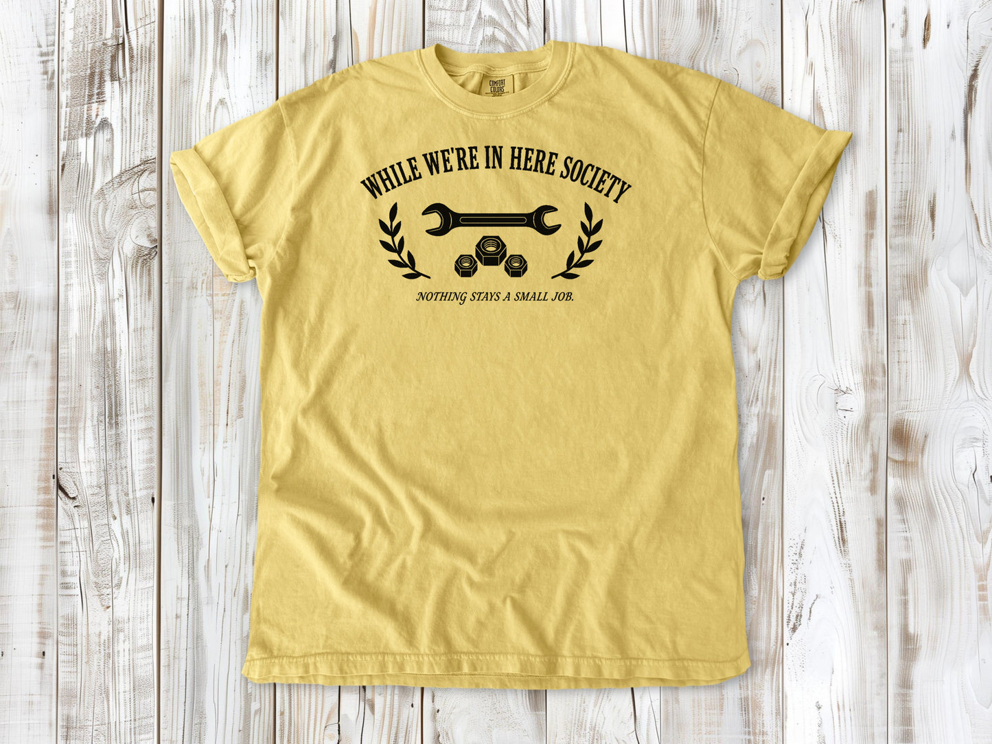 Butter garment-dyed tee with While We're in Here Society garage humor graphic.