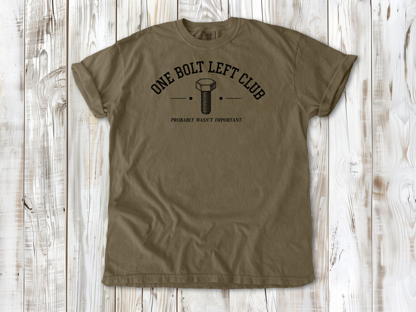 Khaki garment-dyed tee with One Bolt Left Club mechanic humor graphic.