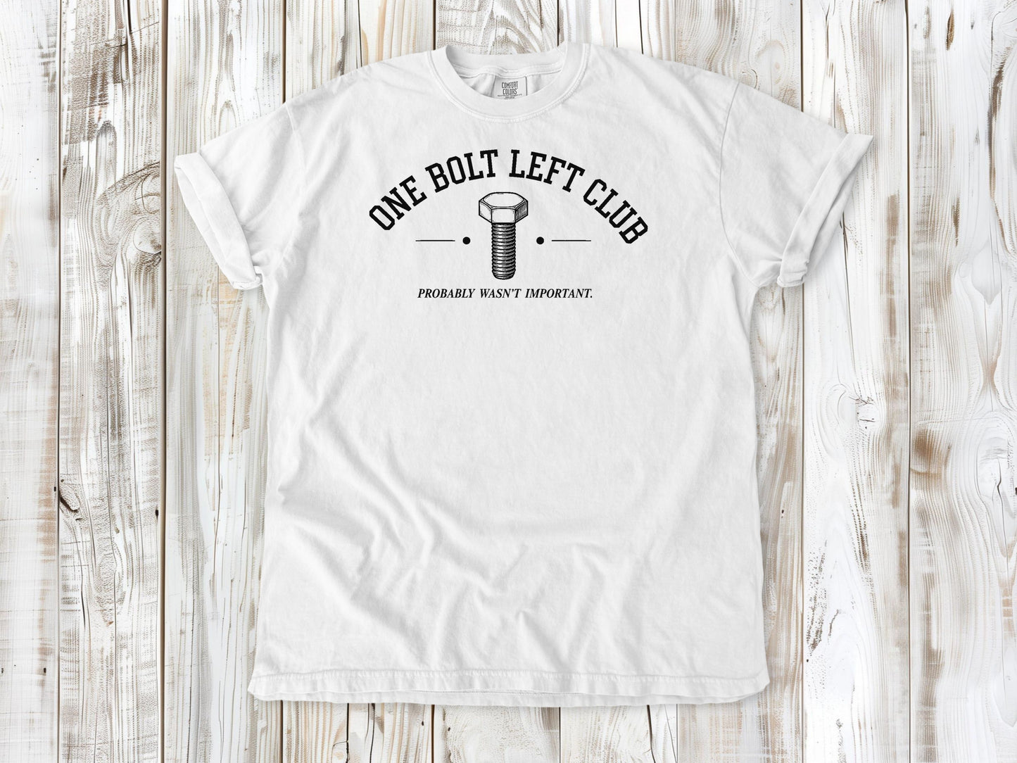 White garment-dyed tee with One Bolt Left Club mechanic humor graphic.