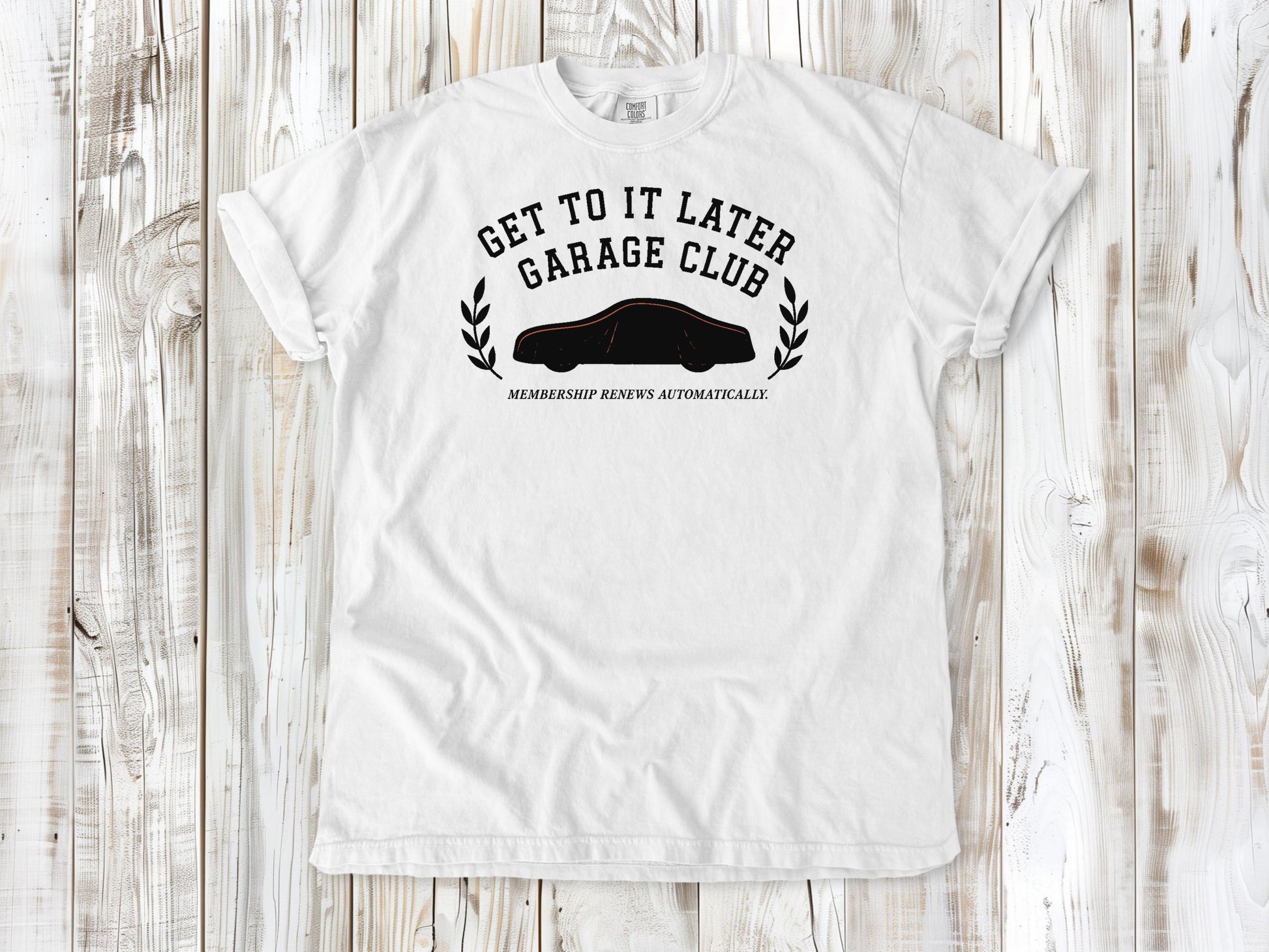 White garment-dyed tee with Get to It Later Garage Club project humor graphic.