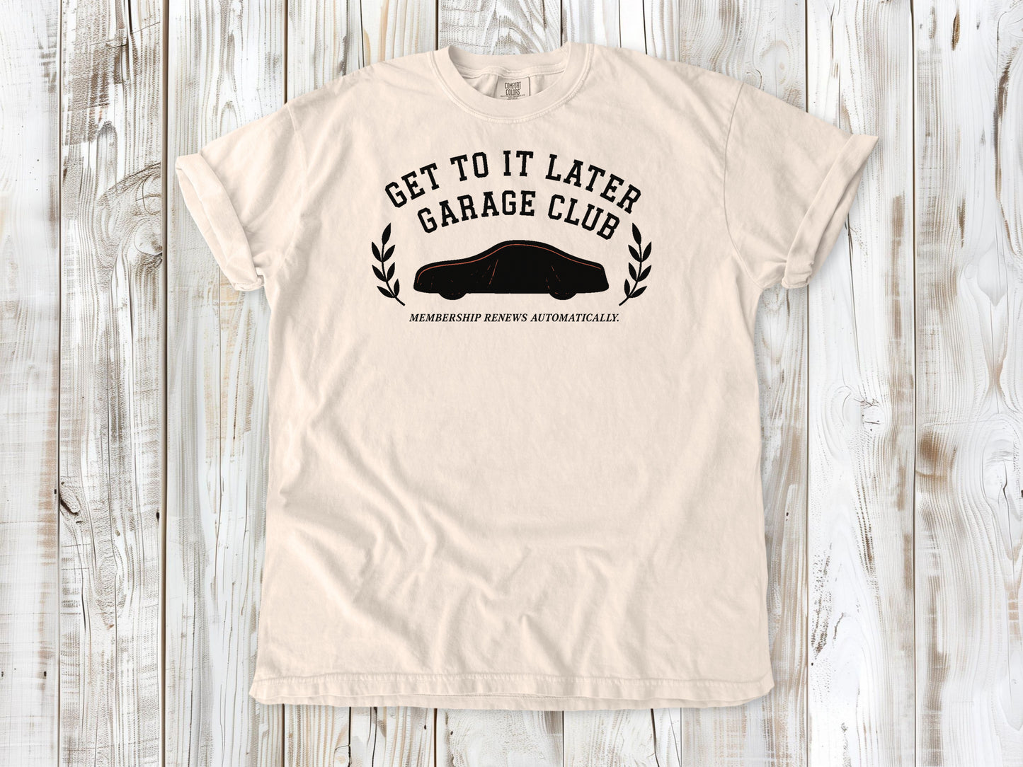 Ivory garment-dyed tee with Get to It Later Garage Club project humor graphic.