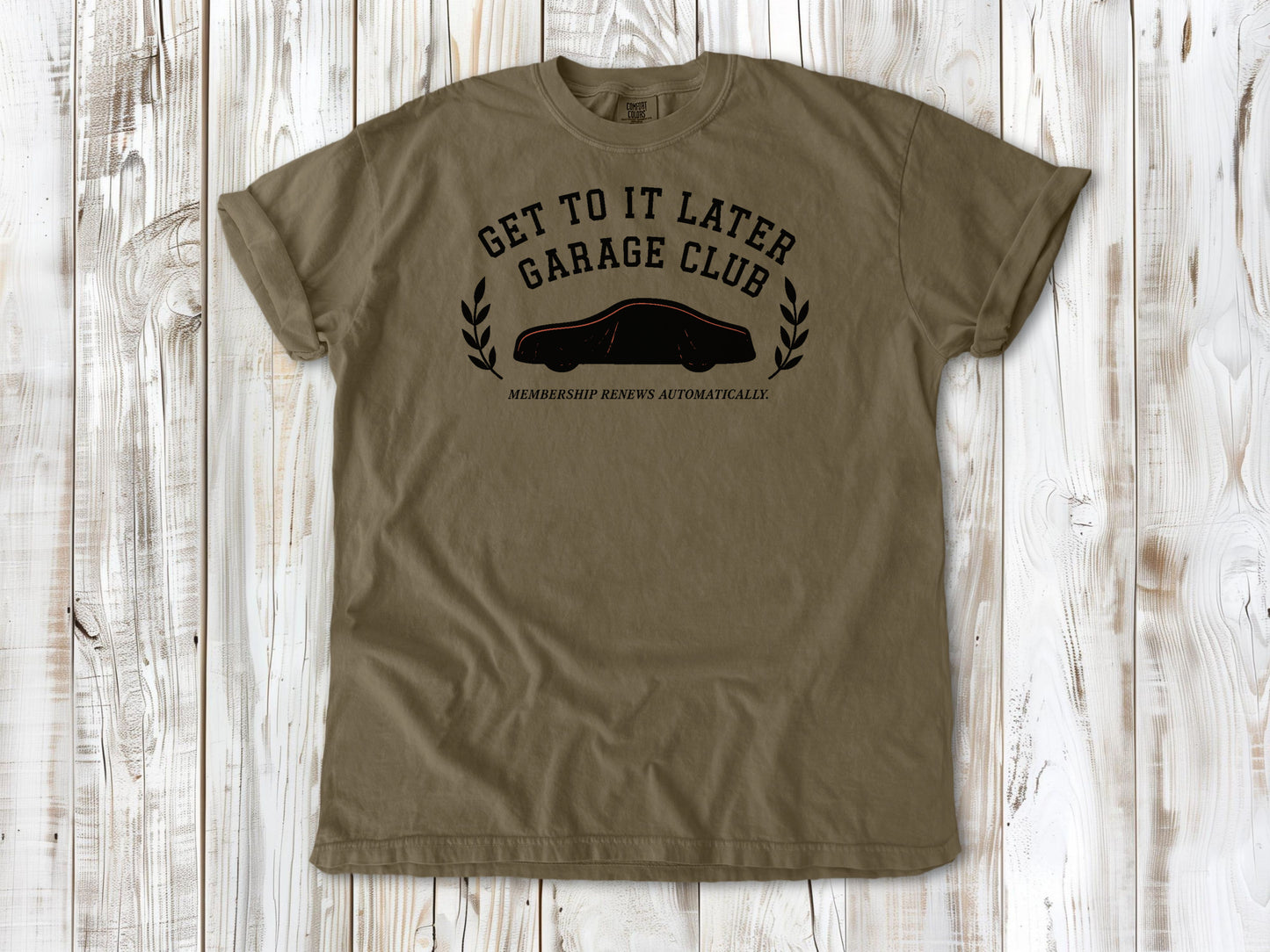 Khaki garment-dyed tee with Get to It Later Garage Club project humor graphic.