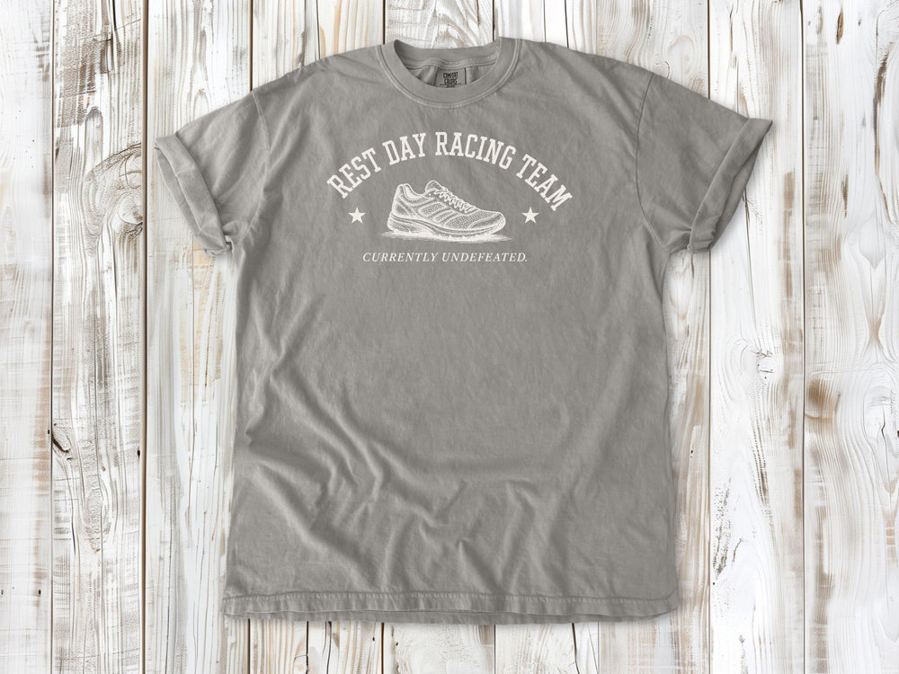 Grey garment-dyed tee with Rest Day Racing Team running humor graphic.