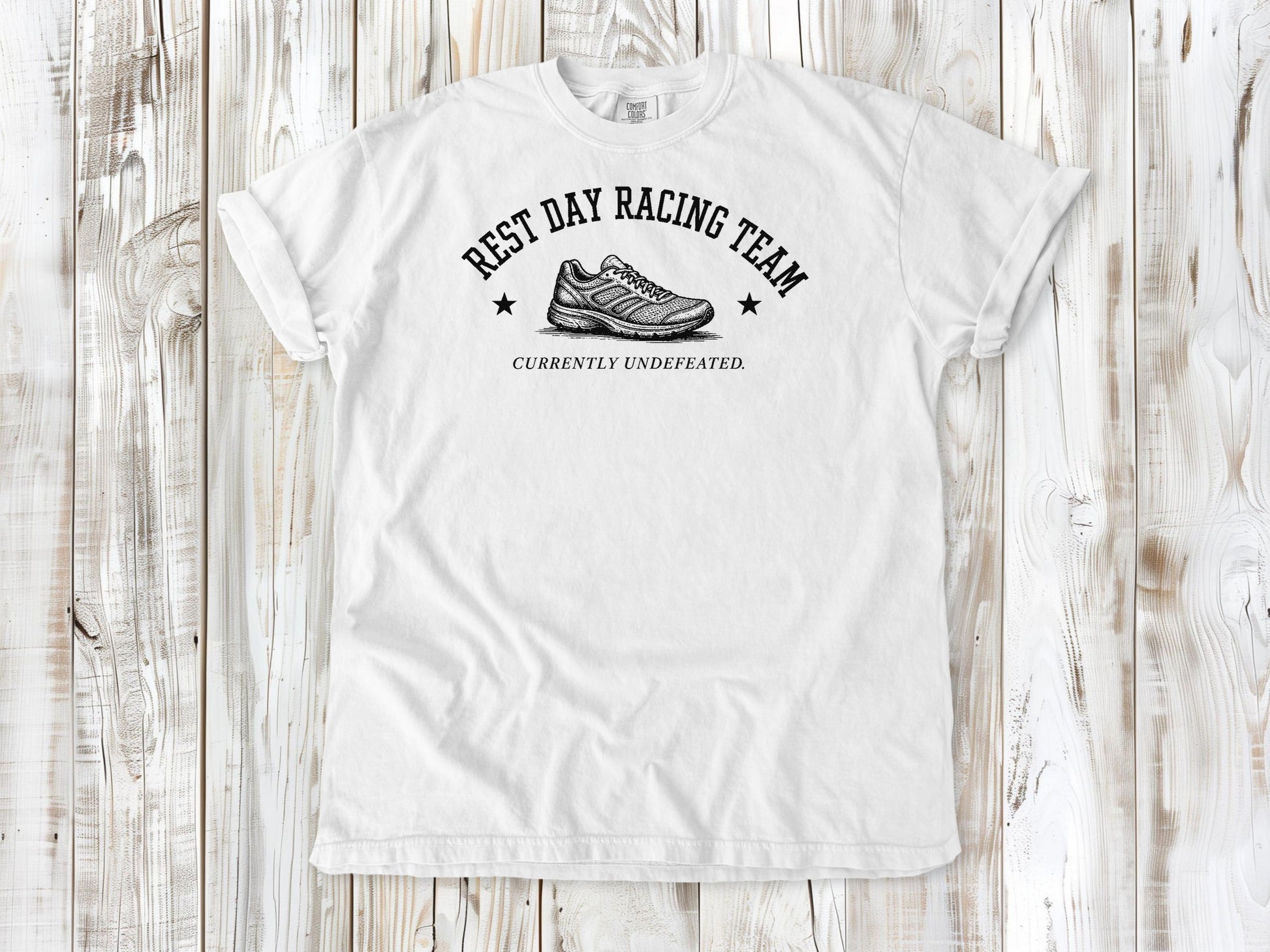White garment-dyed tee with Rest Day Racing Team running humor graphic.