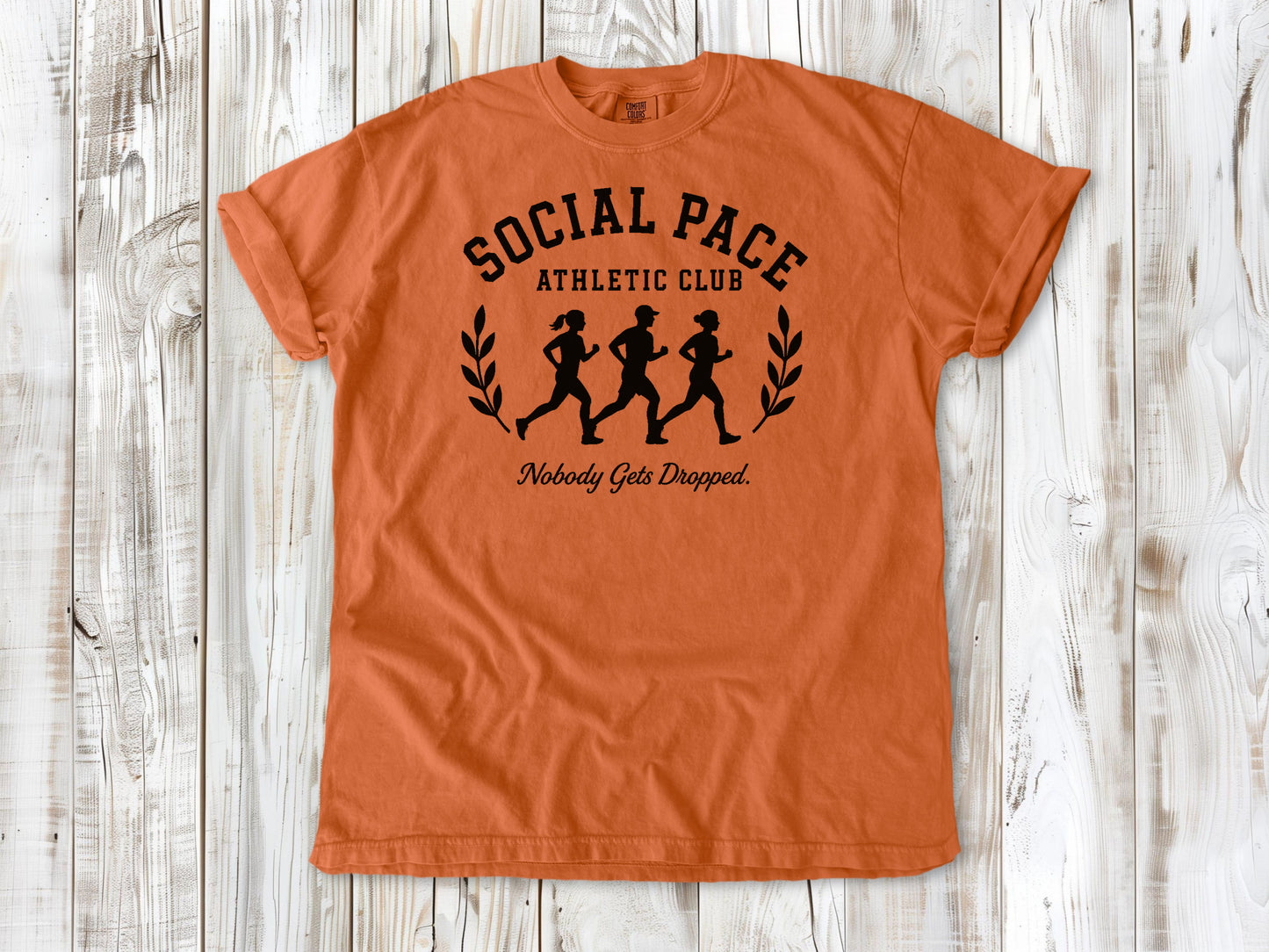 Burnt Orange garment-dyed tee with Social Pace Athletic Club group running graphic.