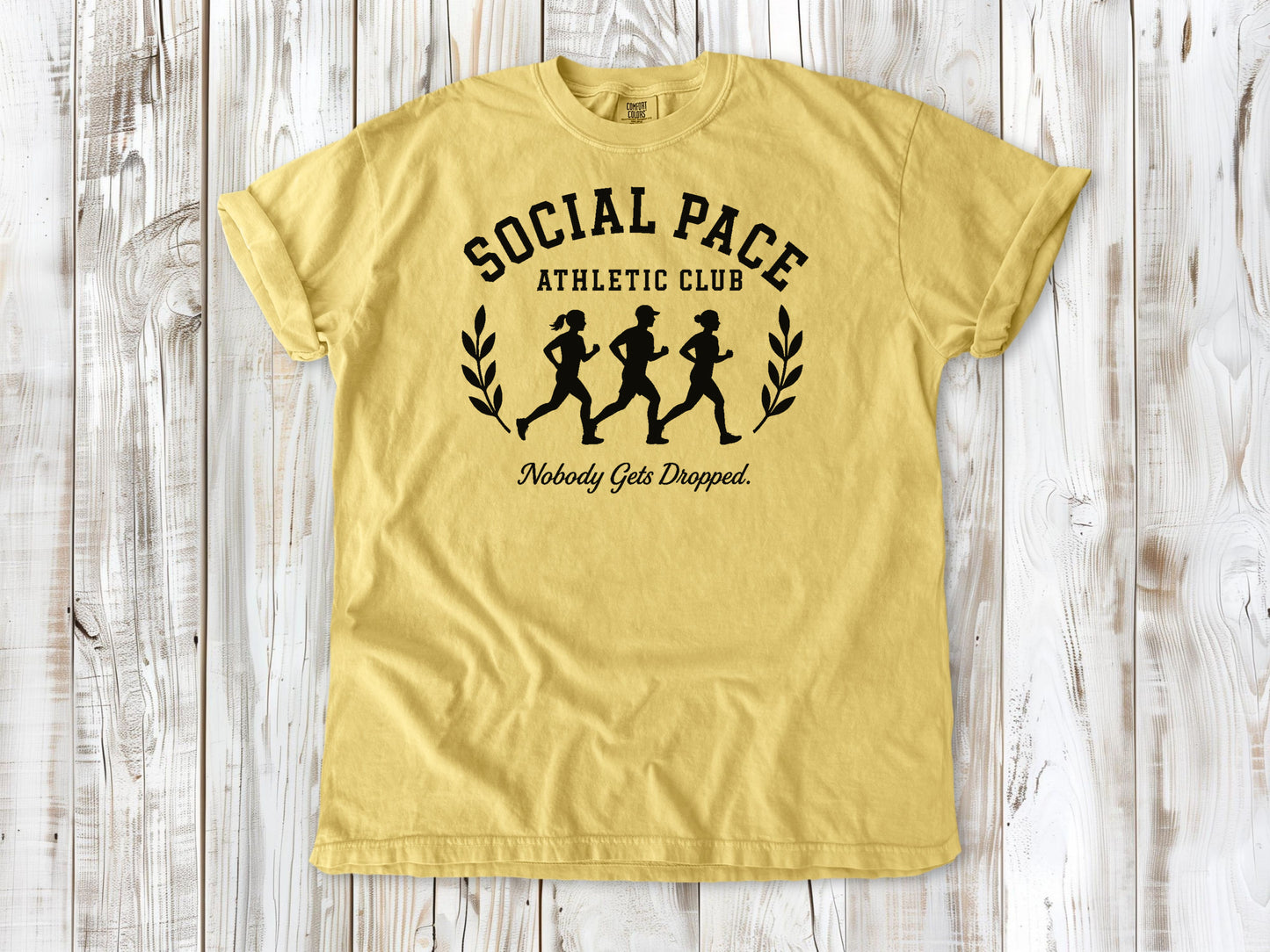 Butter garment-dyed tee with Social Pace Athletic Club group running graphic.