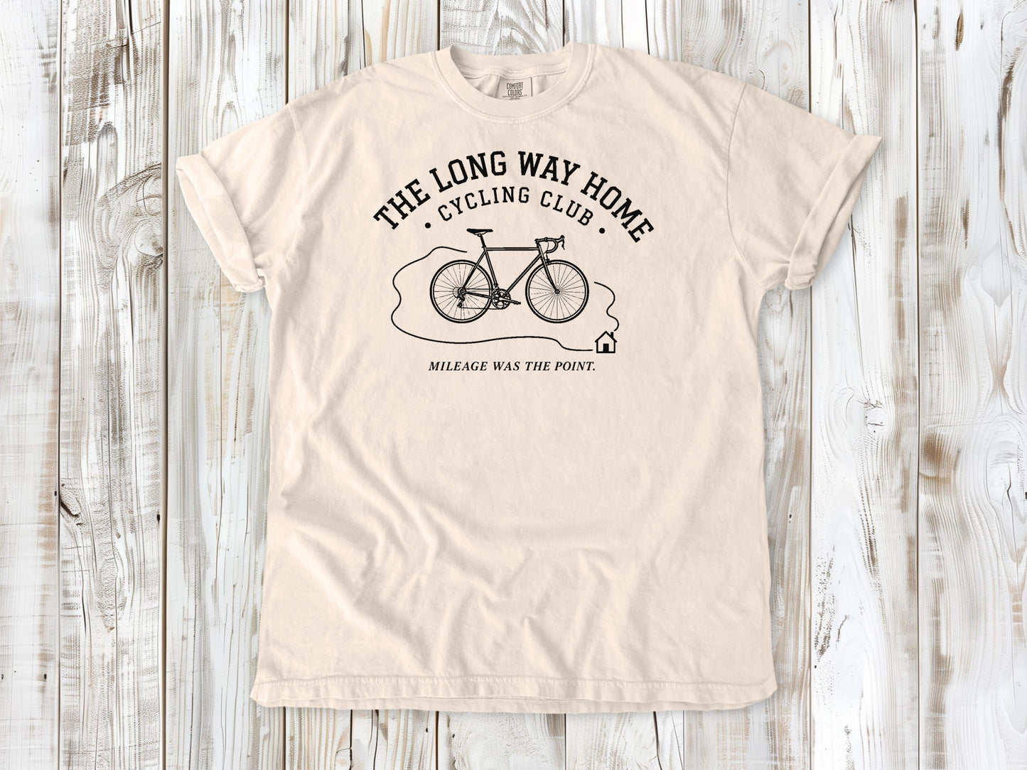 Ivory garment-dyed tee with The Long Way Home Cycling Club bicycle graphic.