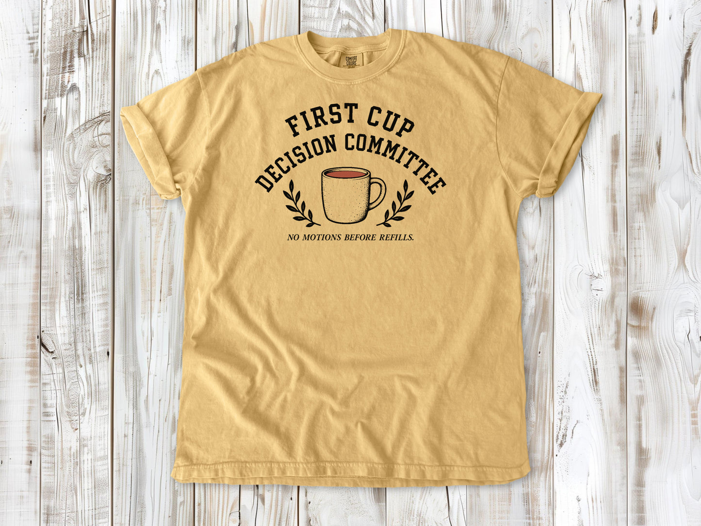 Mustard garment-dyed tee with First Cup Decision Committee coffee club graphic.