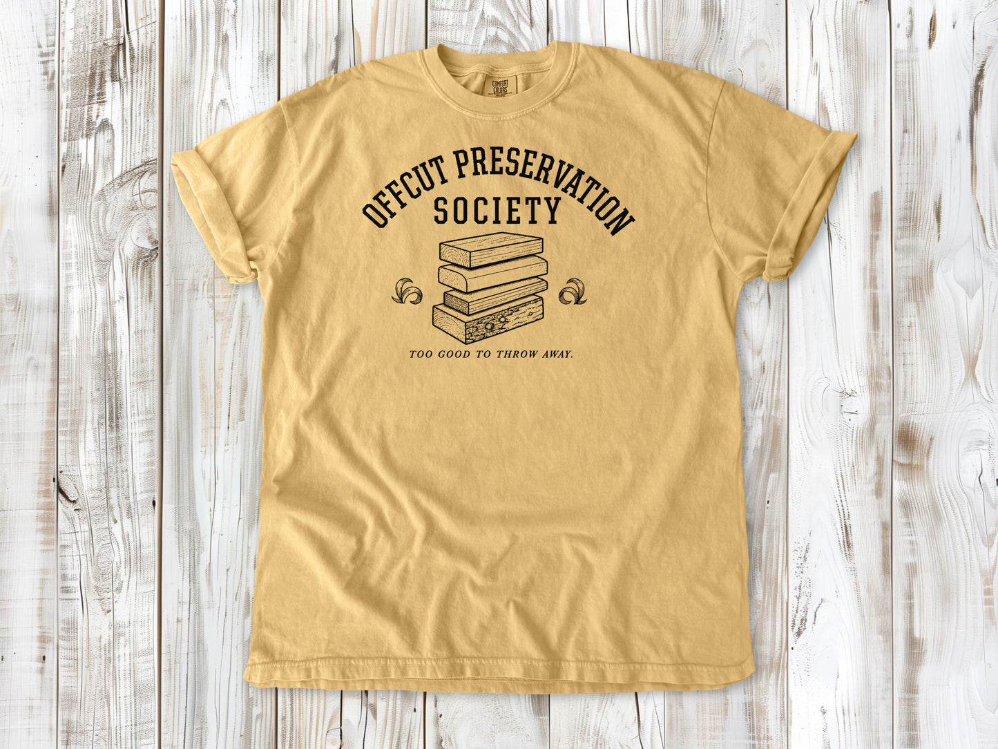 Mustard garment-dyed tee with Offcut Preservation Society woodworking graphic.