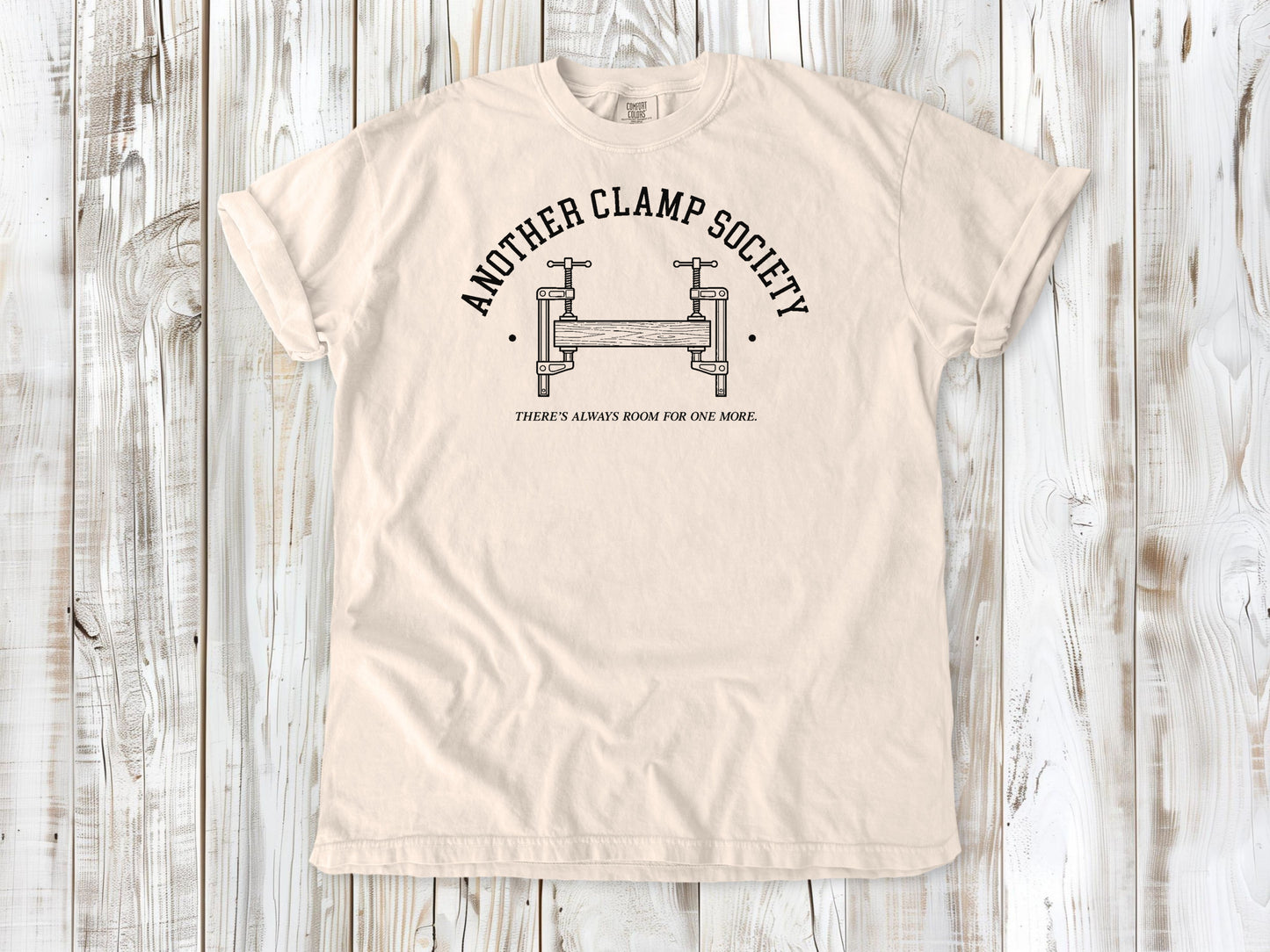 Ivory garment-dyed tee with Another Clamp Society woodworking tools graphic.