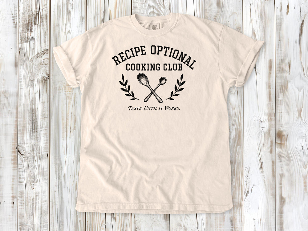 Ivory garment-dyed tee with Recipe Optional Cooking Club kitchen graphic.