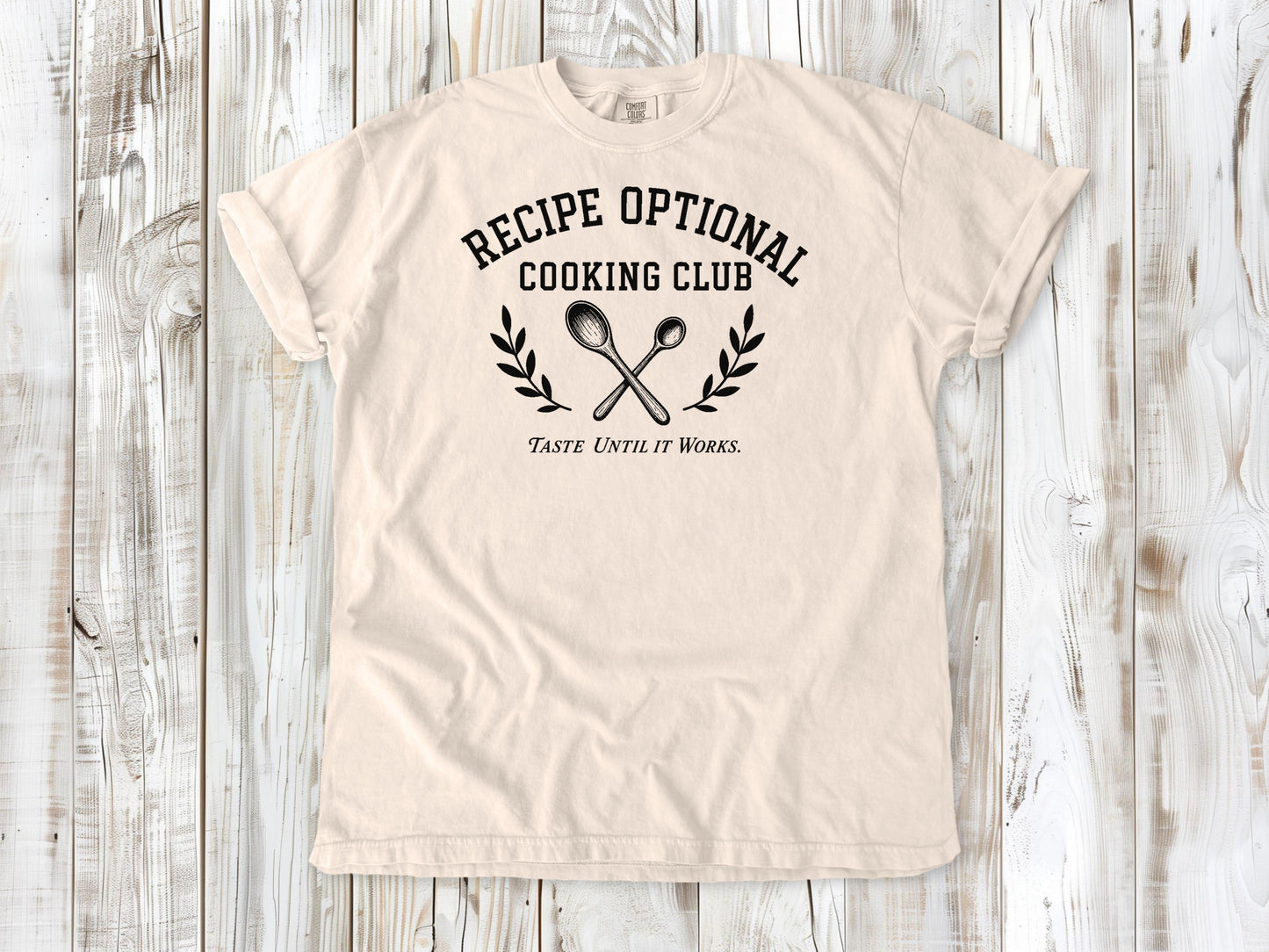 Ivory garment-dyed tee with Recipe Optional Cooking Club kitchen graphic.