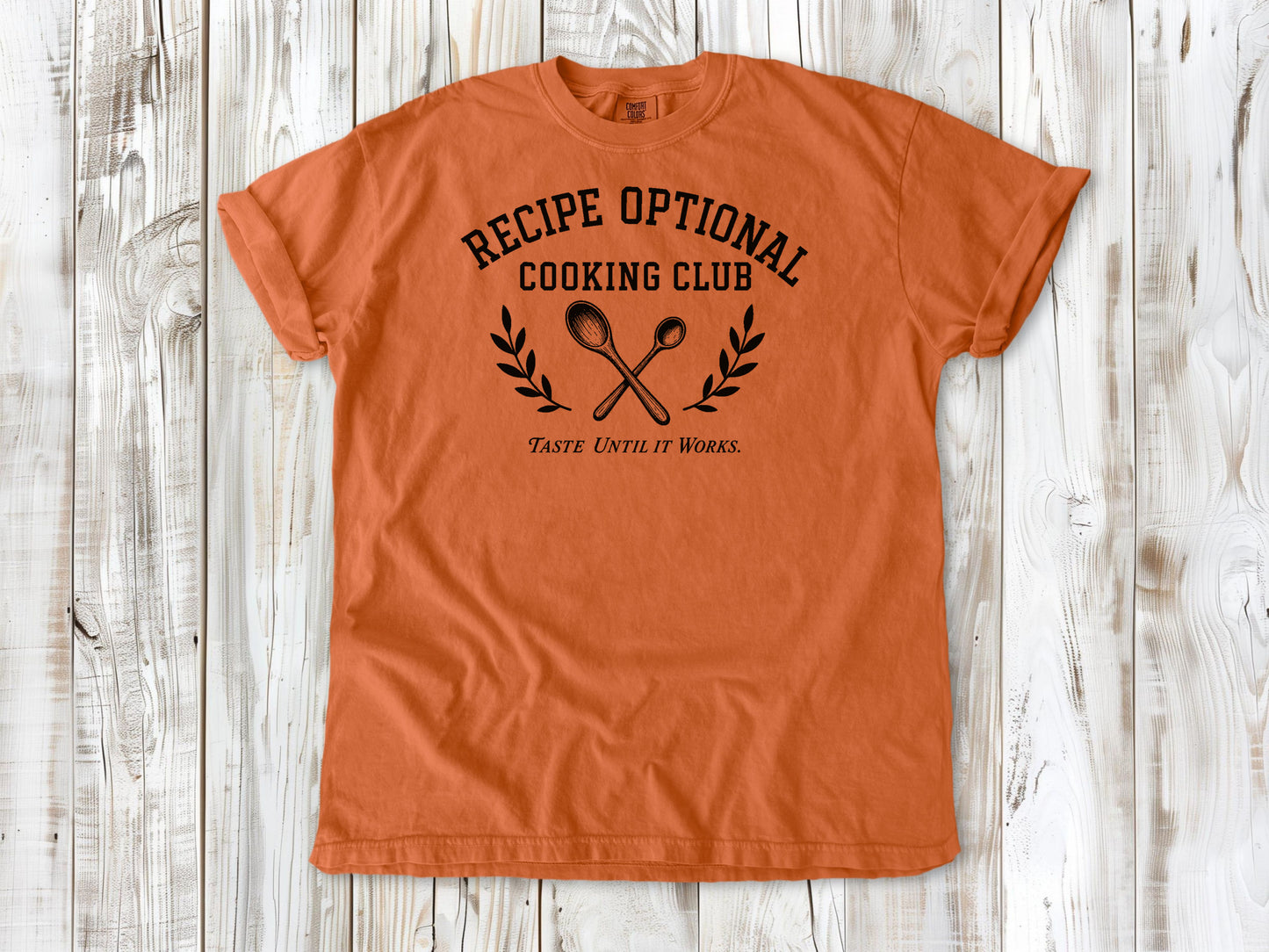 Burnt Orange garment-dyed tee with Recipe Optional Cooking Club kitchen graphic.