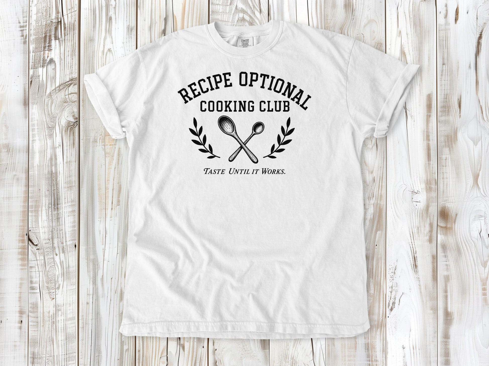 White garment-dyed tee with Recipe Optional Cooking Club kitchen graphic.
