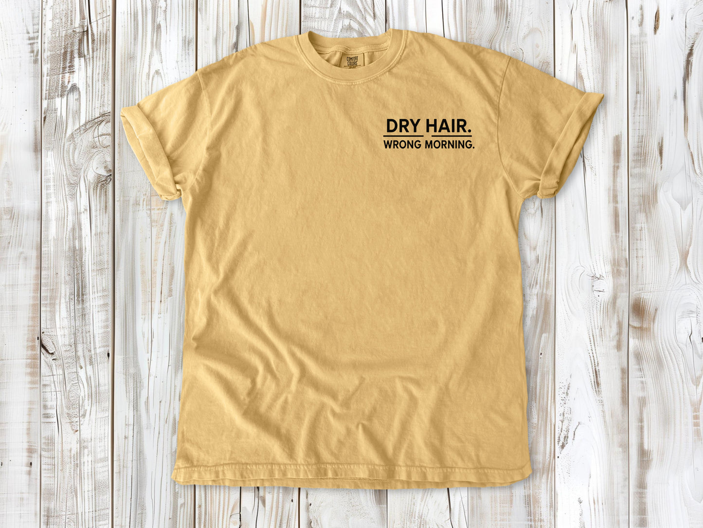 Mustard garment-dyed tee with Dry Hair Wrong Morning small left-chest surf graphic.