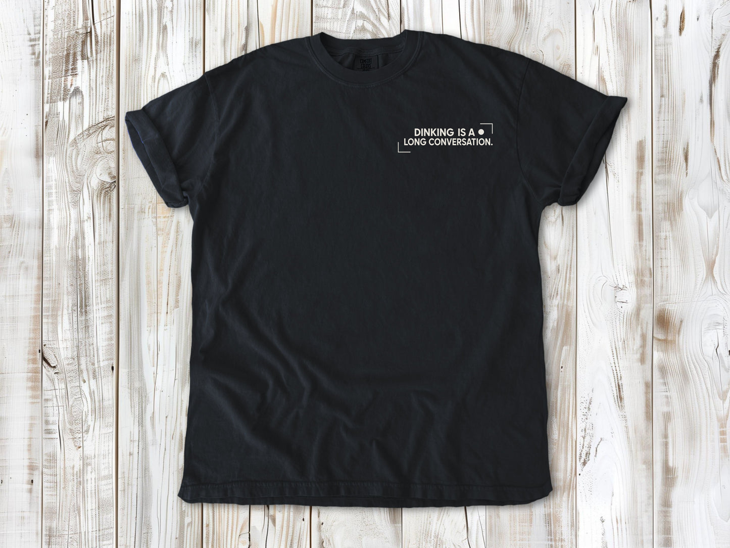Graphite garment-dyed tee with Dinking Is a Long Conversation small left-chest pickleball graphic.