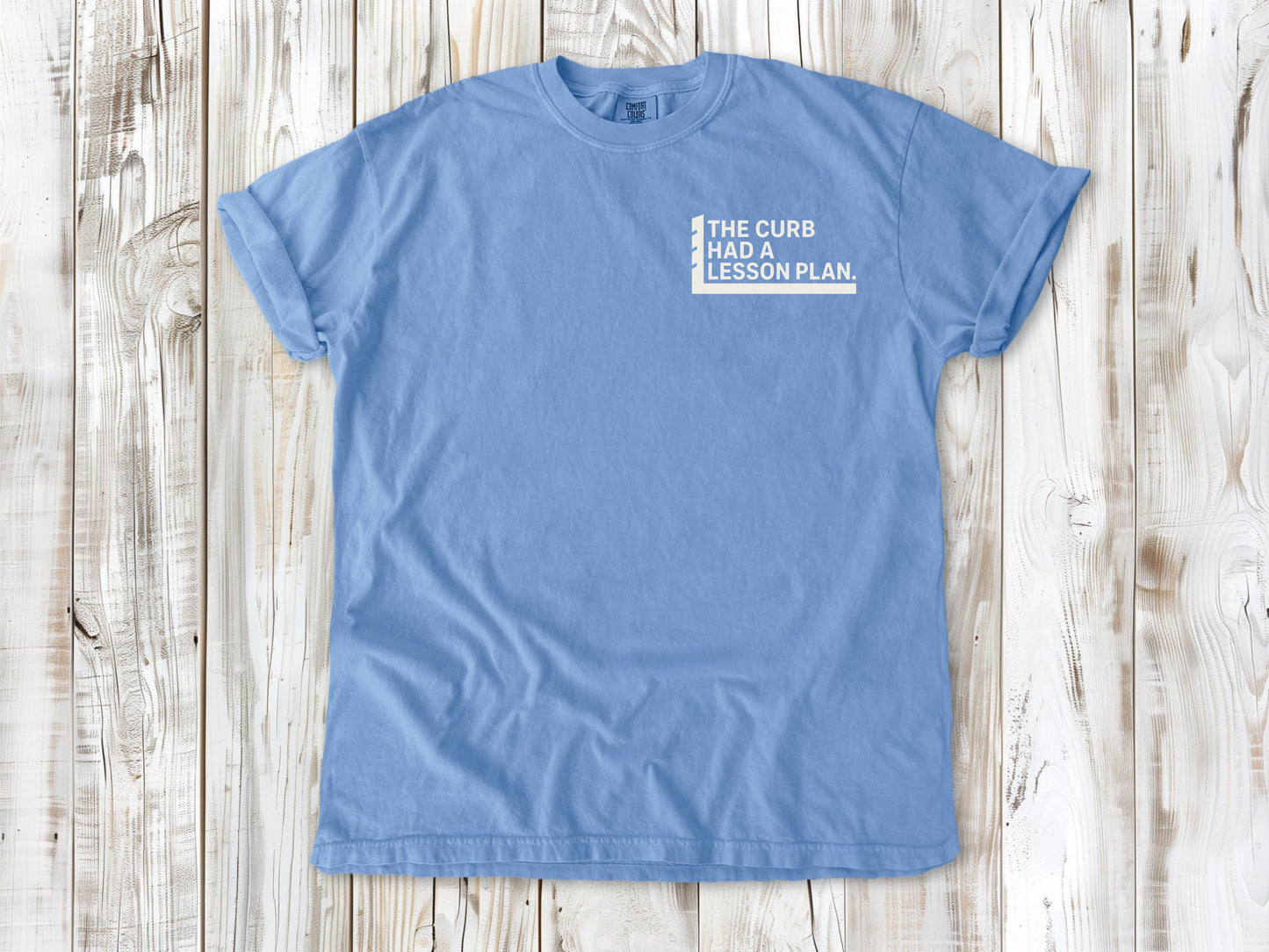 Washed Denim garment-dyed tee with The Curb Had a Lesson Plan small left-chest skate graphic.