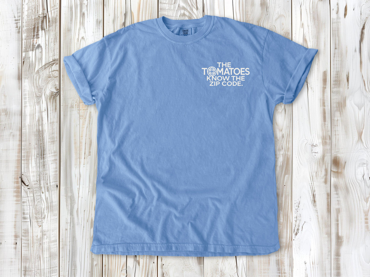 Washed Denim garment-dyed tee with The Tomatoes Know the Zip Code small left-chest gardening graphic.