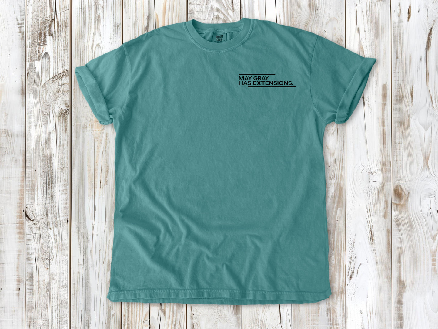 Seafoam garment-dyed tee with May Gray Has Extensions small left-chest coastal graphic.