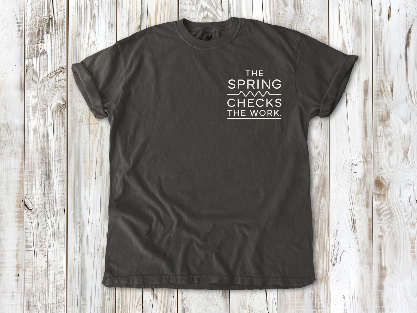 Pepper garment-dyed tee with The Spring Checks the Work small left-chest Pilates graphic.