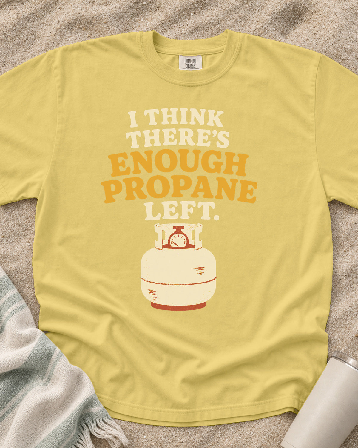 Butter garment-dyed tee with I Think There’s Enough Propane Left griddle graphic.
