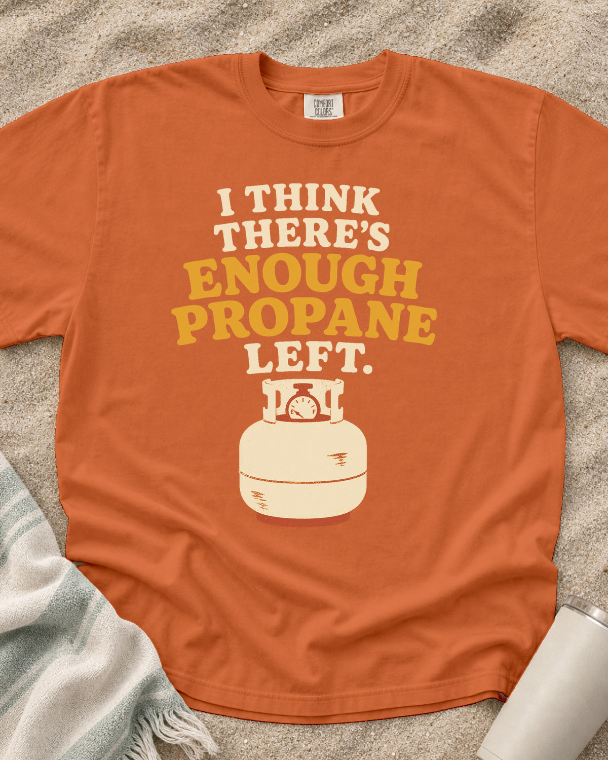 Burnt Orange garment-dyed tee with I Think There’s Enough Propane Left griddle graphic.