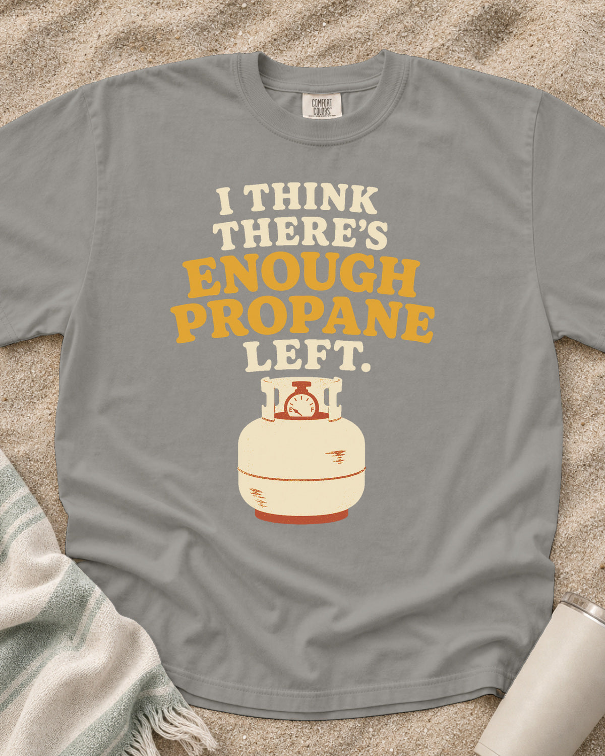 Grey garment-dyed tee with I Think There’s Enough Propane Left griddle graphic.