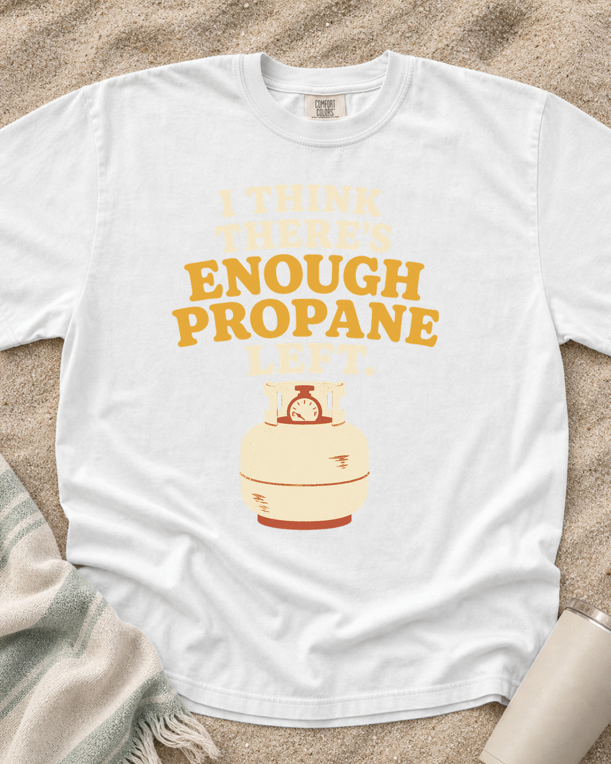 White garment-dyed tee with I Think There’s Enough Propane Left griddle graphic.