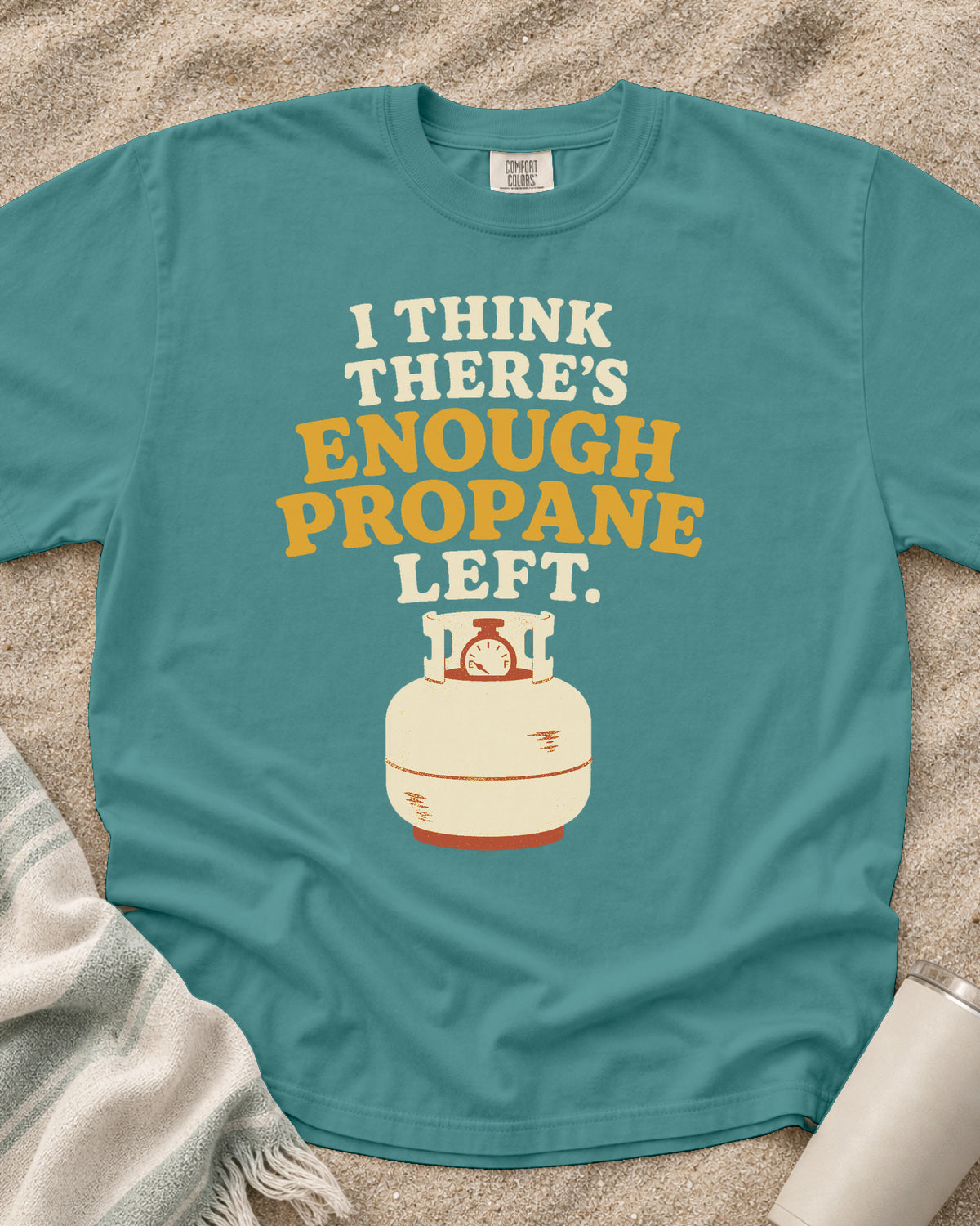 Seafoam garment-dyed tee with I Think There’s Enough Propane Left griddle graphic.