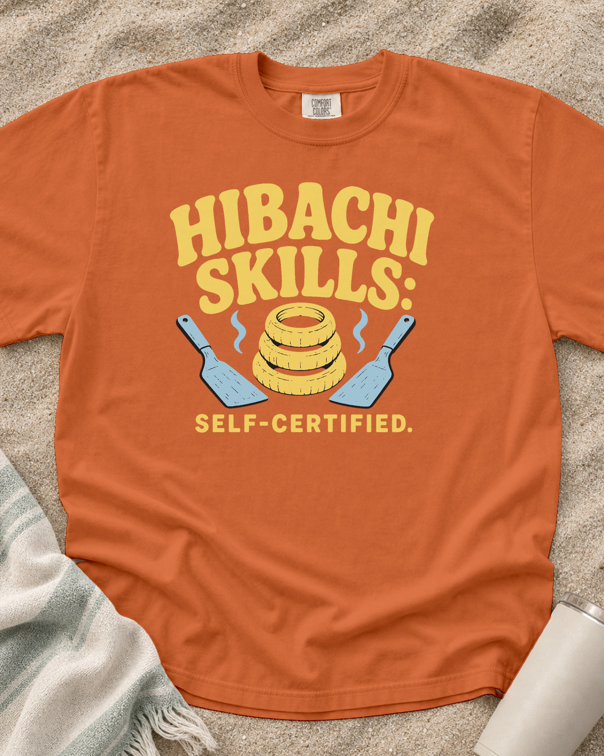 Burnt Orange garment-dyed tee with Hibachi Skills Self-Certified griddle graphic.