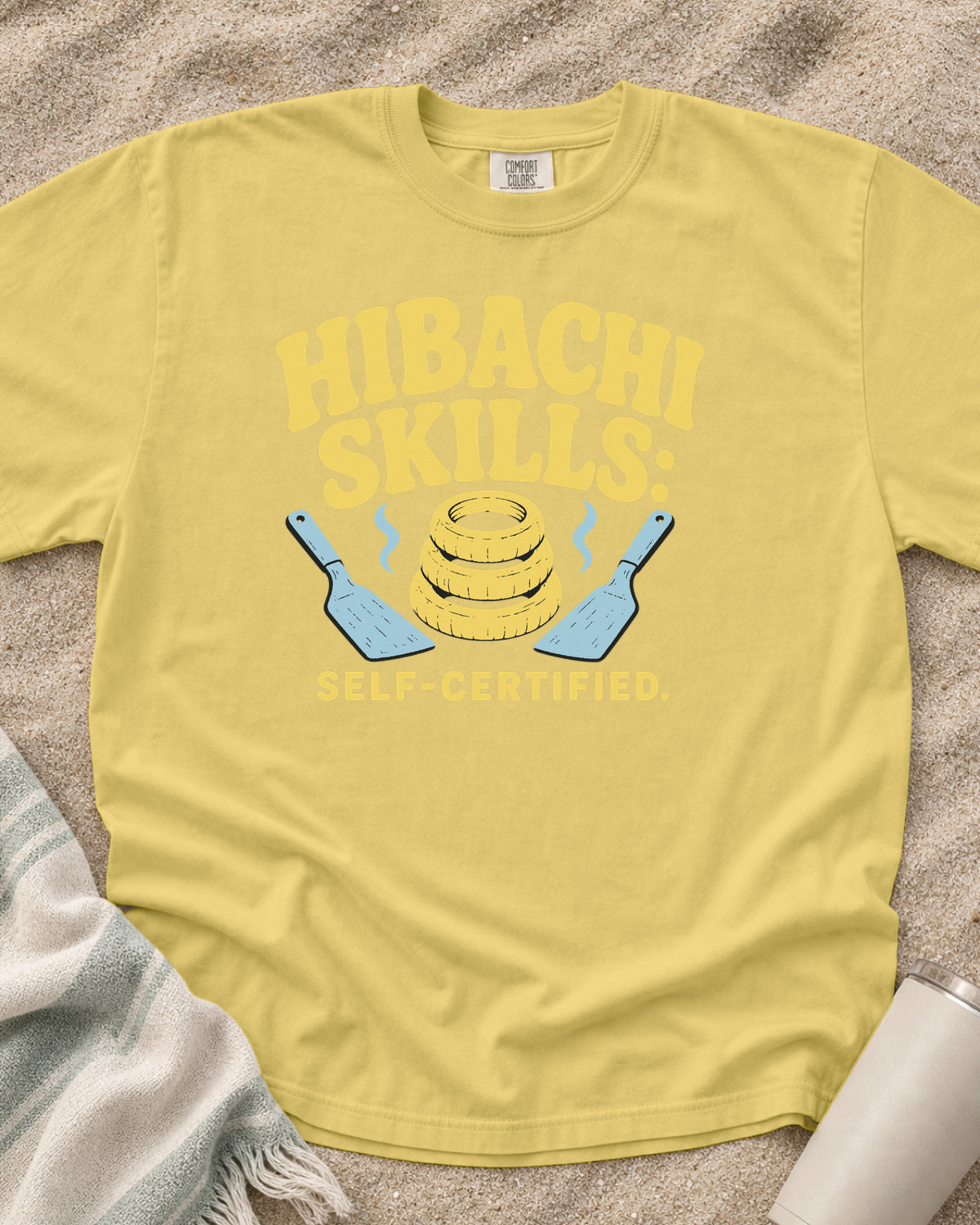 Butter garment-dyed tee with Hibachi Skills Self-Certified griddle graphic.