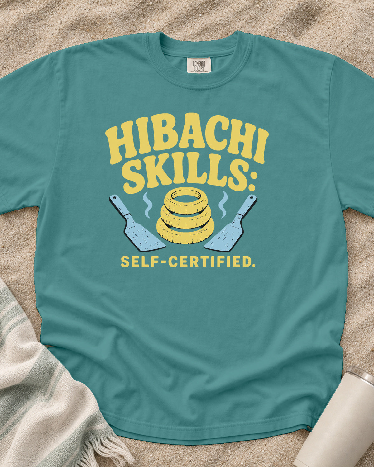 Seafoam garment-dyed tee with Hibachi Skills Self-Certified griddle graphic.