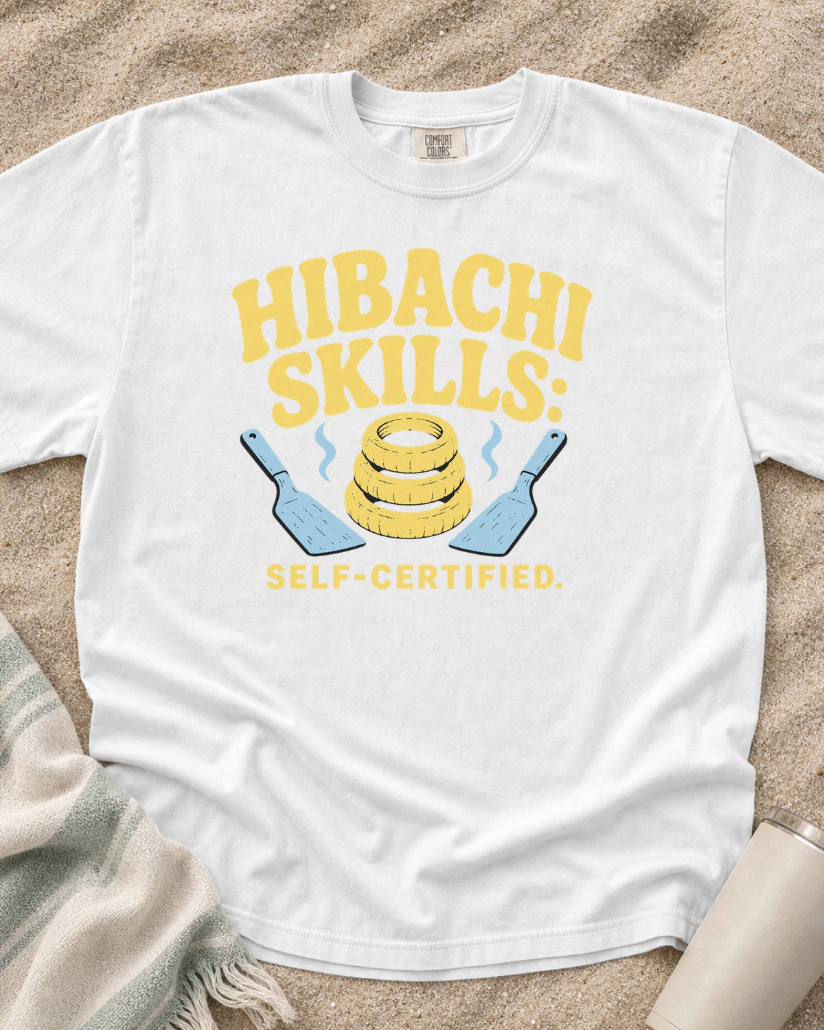 White garment-dyed tee with Hibachi Skills Self-Certified griddle graphic.
