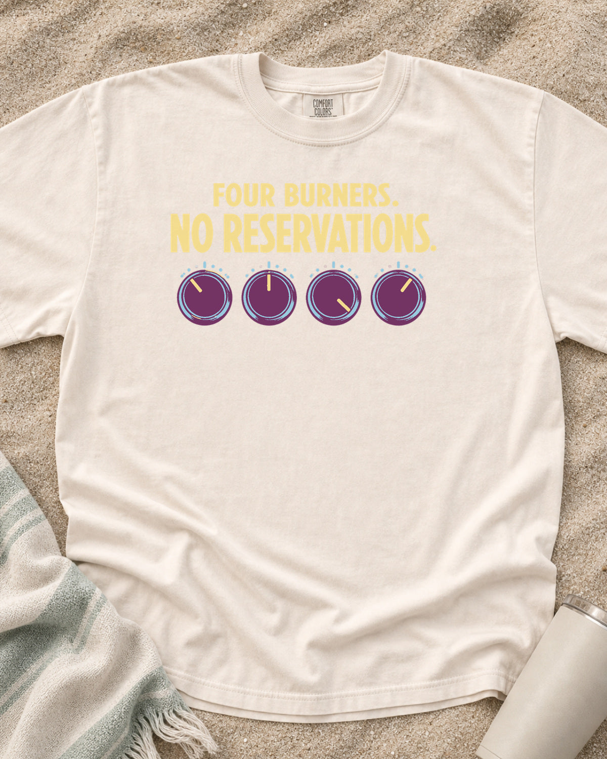 Ivory garment-dyed tee with Four Burners No Reservations griddle graphic.