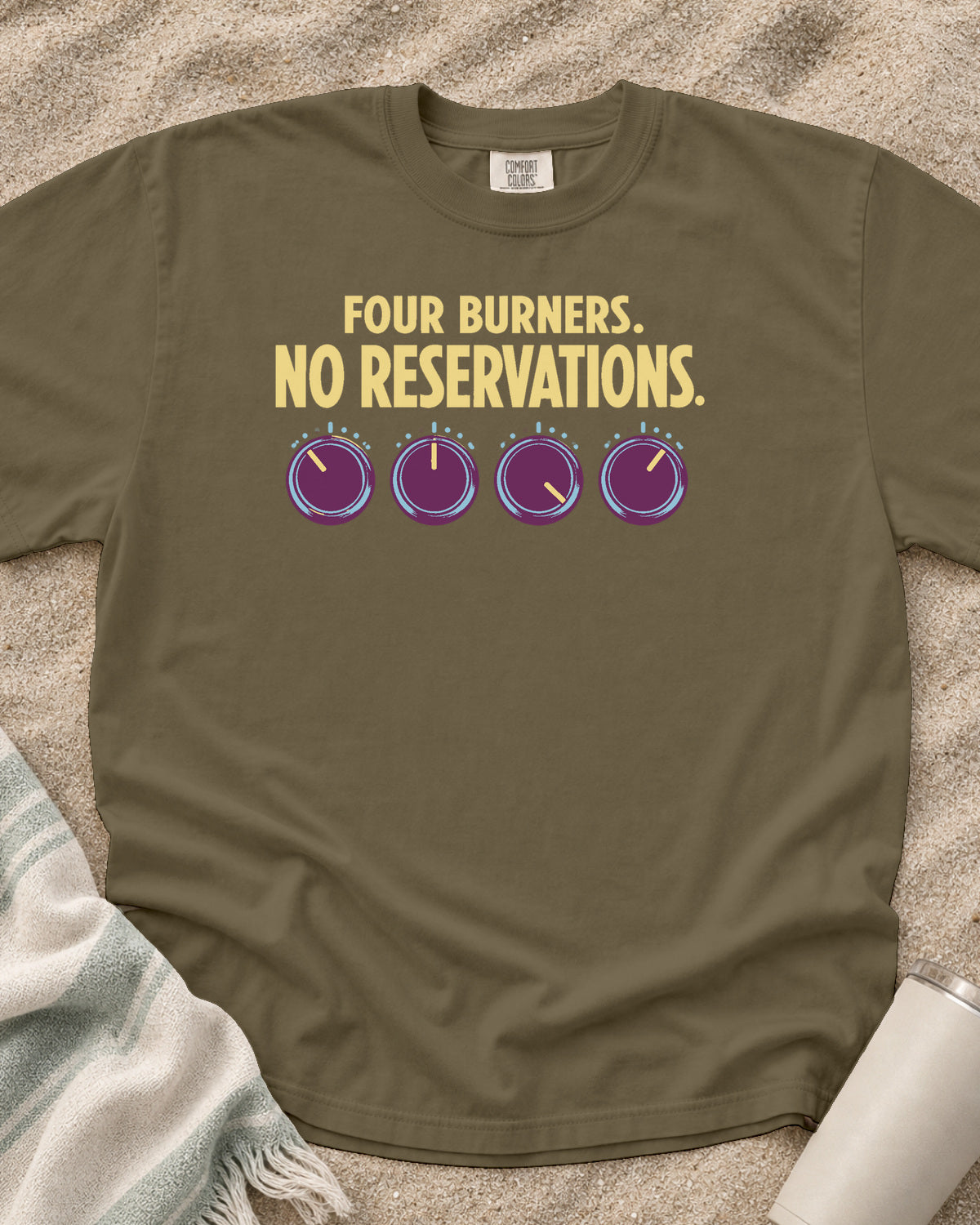 Khaki garment-dyed tee with Four Burners No Reservations griddle graphic.