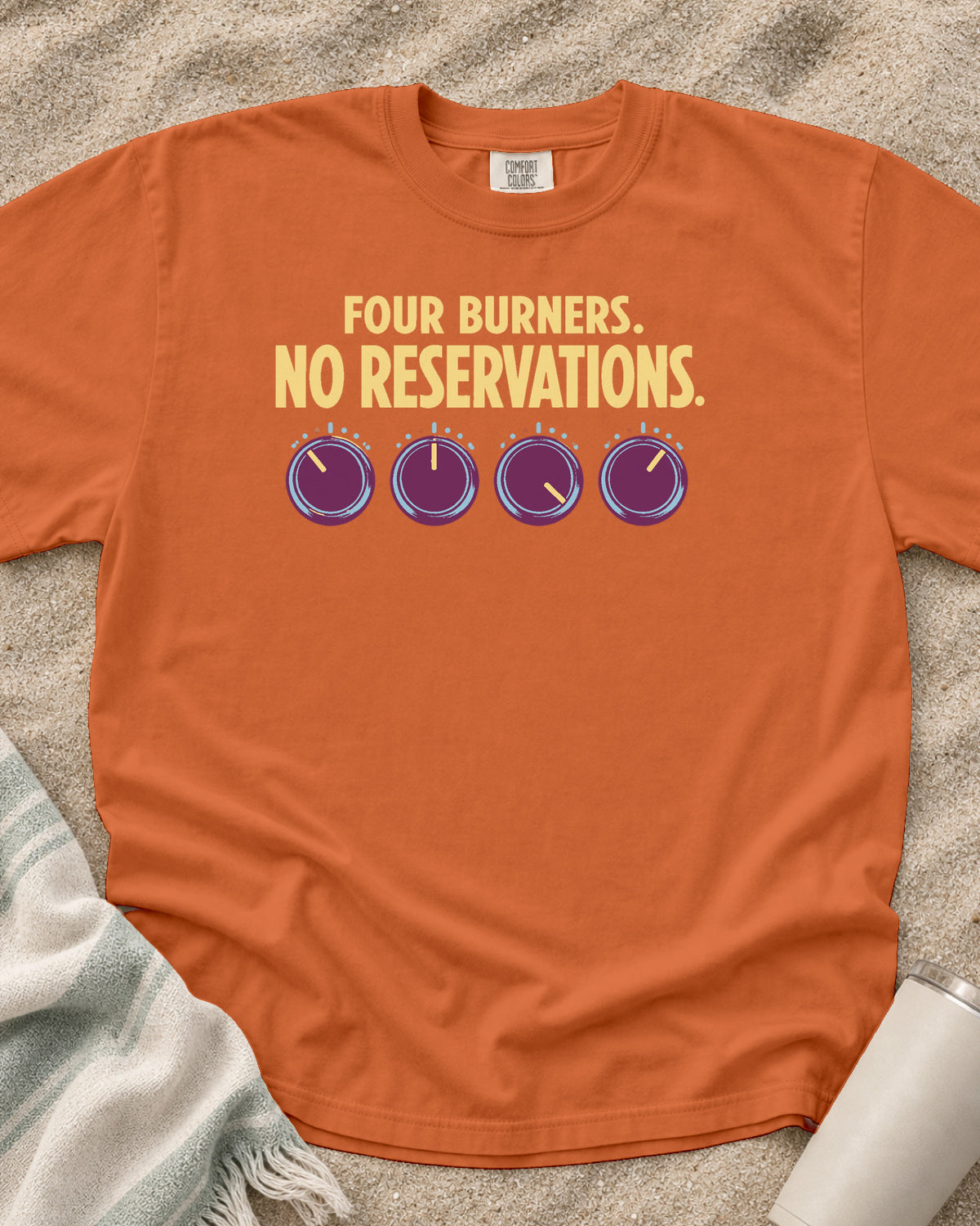 Burnt Orange garment-dyed tee with Four Burners No Reservations griddle graphic.