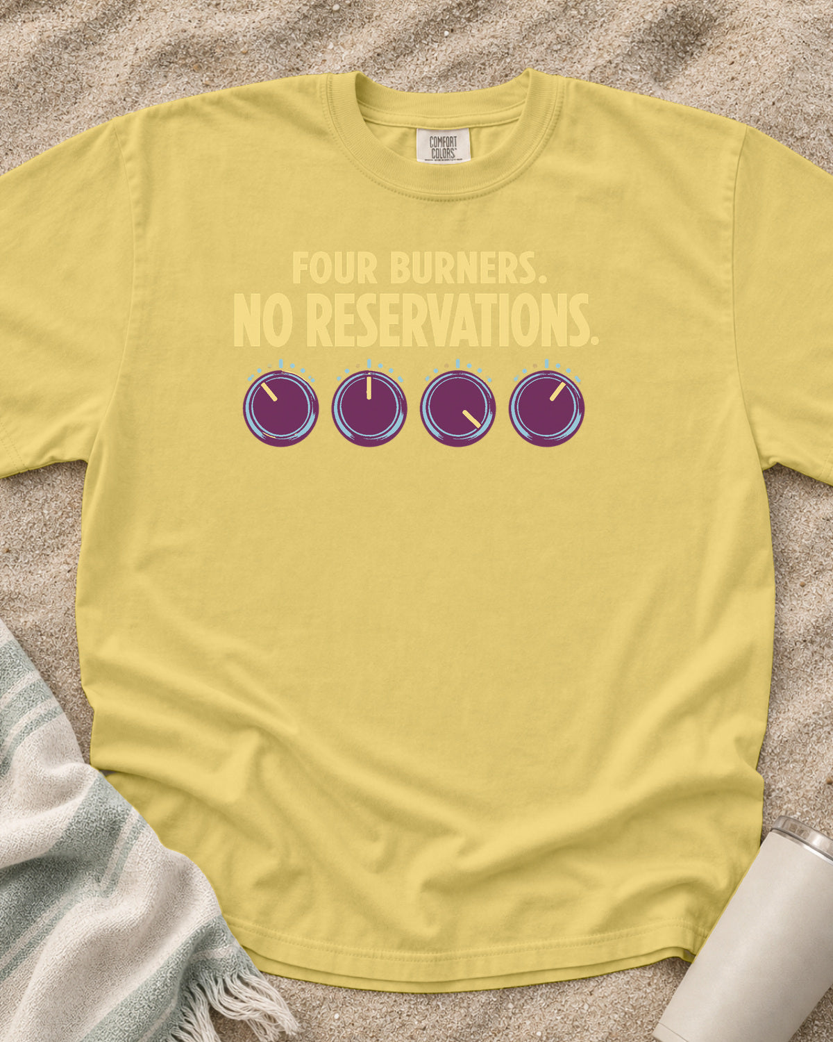 Butter garment-dyed tee with Four Burners No Reservations griddle graphic.